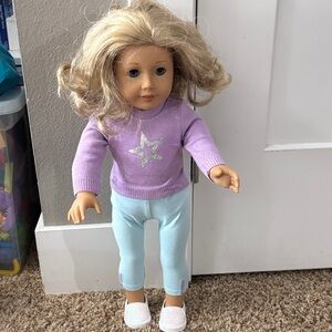 American Girl doll with blonde hair, blue eyes, and tan skin